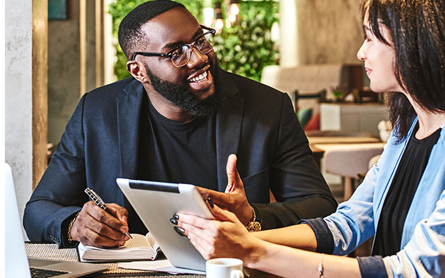 Two people sitting at a table talking