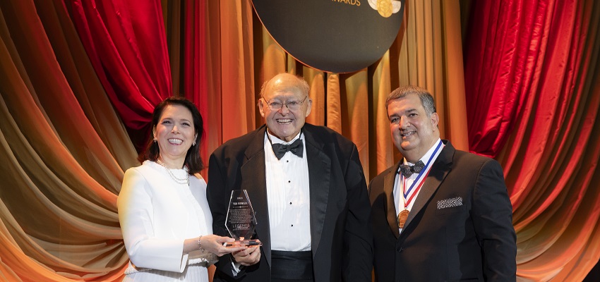 Michelle Korsmo, left, and Golden Corral President & CEO Lance Trenary, right, present Ted Fowler with his Legends Award.