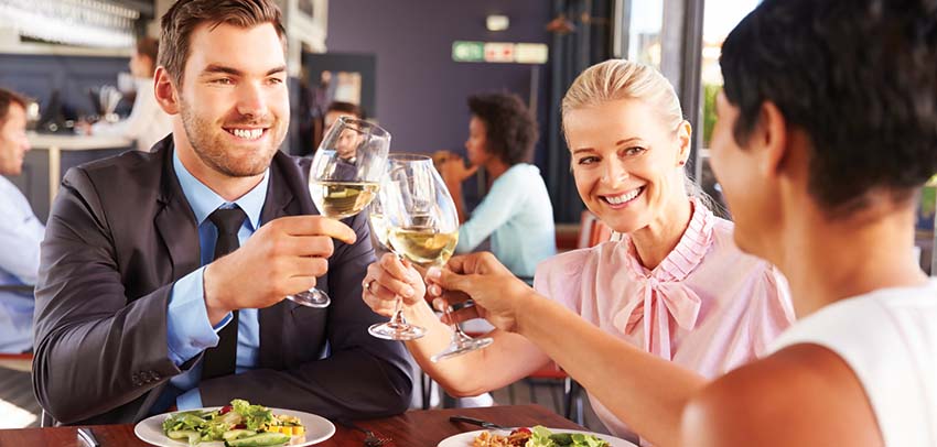 One man and two women having dinner