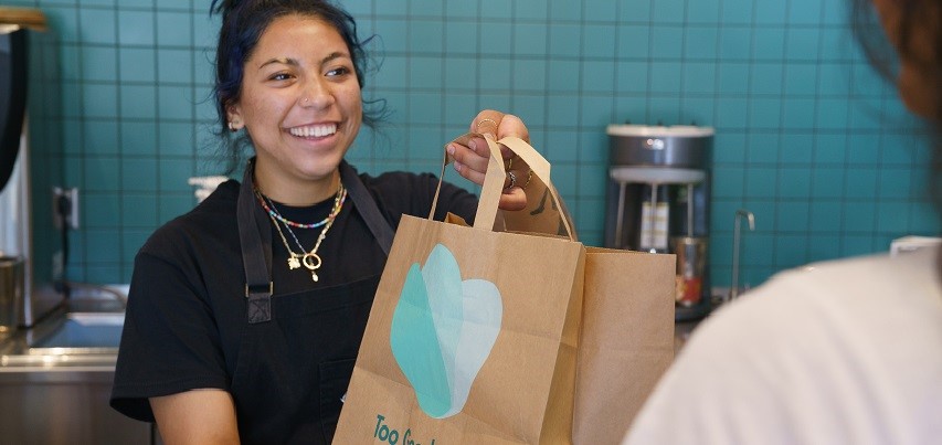 Restaurant employee with a to go bag