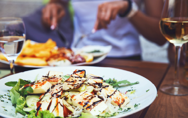 Photo of a salad topped with chicken