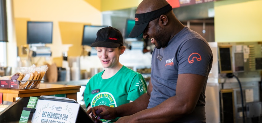 Restaurant employees working together at register