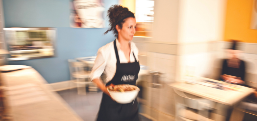 Waitress carrying a bowl with food